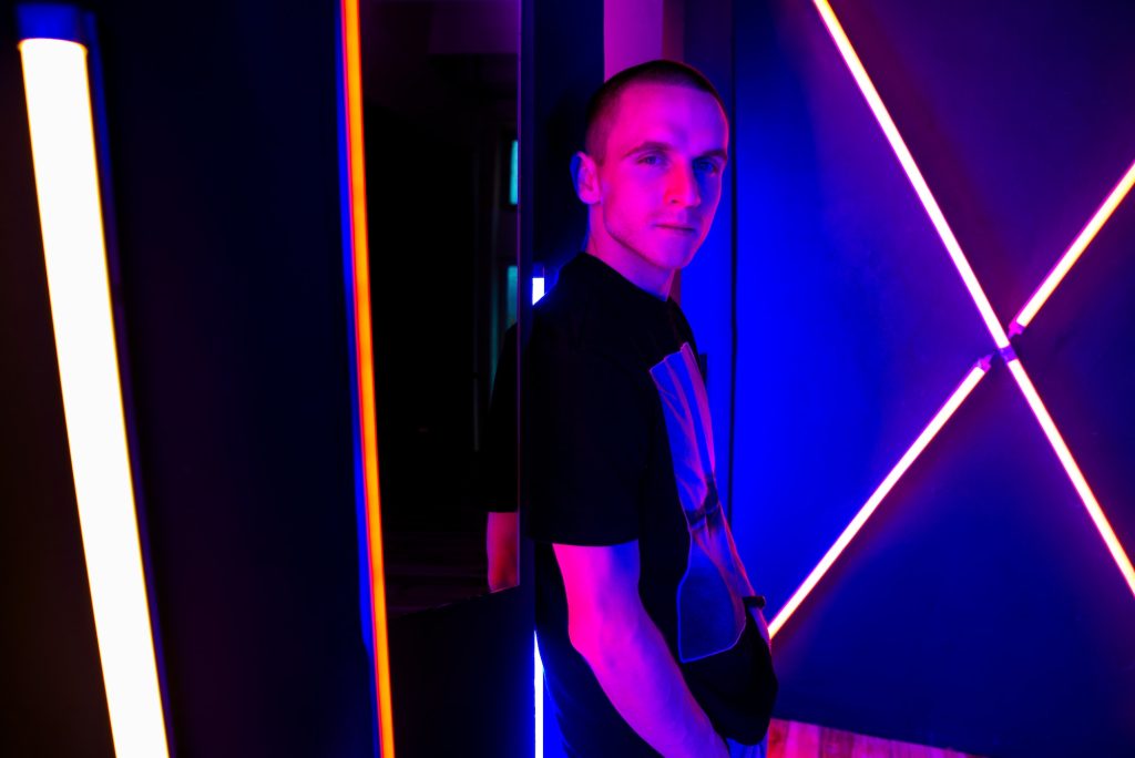 A young man in neon light